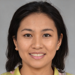 Joyful asian young-adult female with medium  brown hair and brown eyes