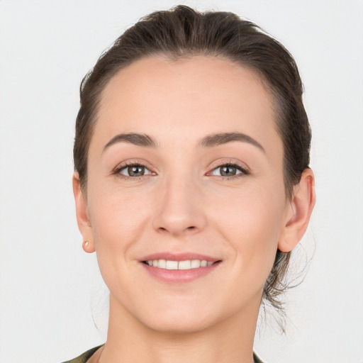 Joyful white young-adult female with short  brown hair and grey eyes