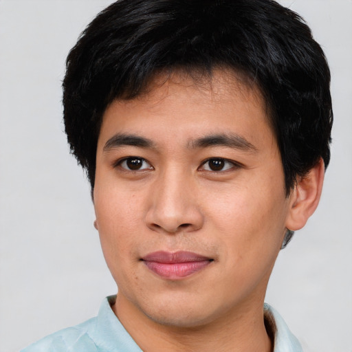 Joyful asian young-adult male with short  black hair and brown eyes