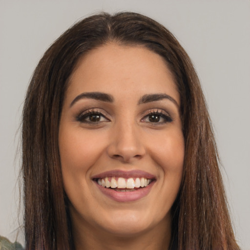 Joyful white young-adult female with long  brown hair and brown eyes