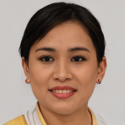 Joyful asian young-adult female with short  brown hair and brown eyes