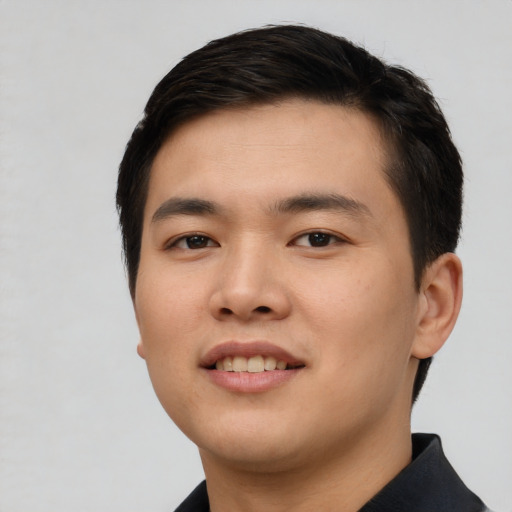 Joyful asian young-adult male with short  black hair and brown eyes