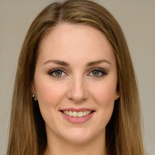 Joyful white young-adult female with long  brown hair and green eyes