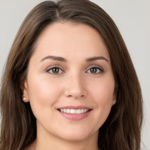 Joyful white young-adult female with long  brown hair and brown eyes