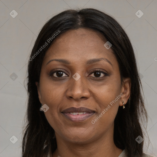 Joyful black adult female with long  brown hair and brown eyes