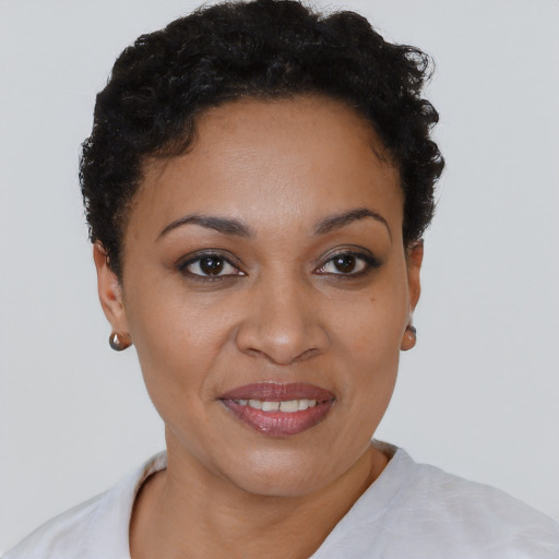Joyful black young-adult female with short  brown hair and brown eyes