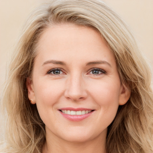 Joyful white young-adult female with long  brown hair and blue eyes