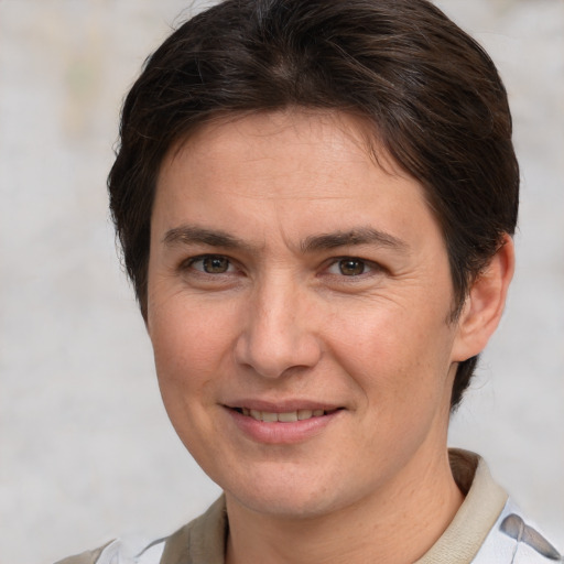 Joyful white adult female with short  brown hair and brown eyes