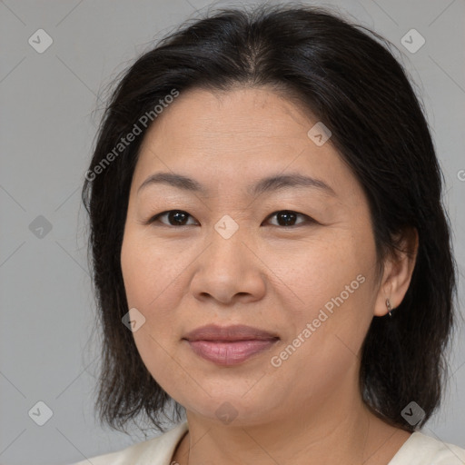 Joyful asian adult female with medium  brown hair and brown eyes