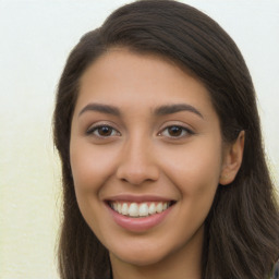 Joyful latino young-adult female with long  brown hair and brown eyes