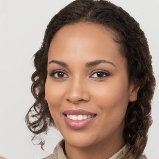 Joyful latino young-adult female with long  brown hair and brown eyes