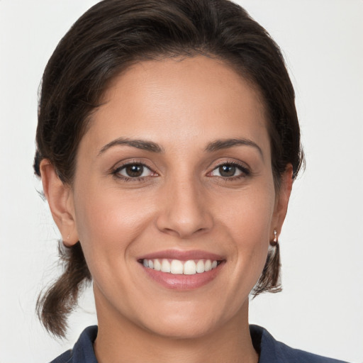 Joyful white young-adult female with medium  brown hair and brown eyes