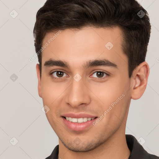 Joyful white young-adult male with short  brown hair and brown eyes