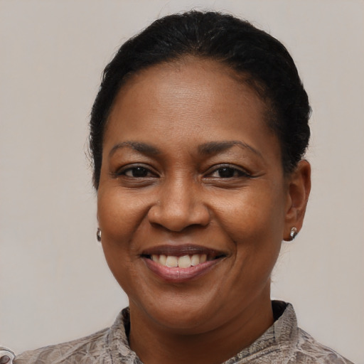 Joyful black adult female with short  brown hair and brown eyes