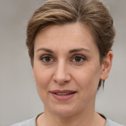 Joyful white adult female with short  brown hair and grey eyes