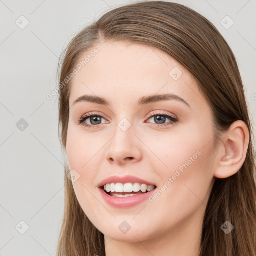 Joyful white young-adult female with long  brown hair and grey eyes