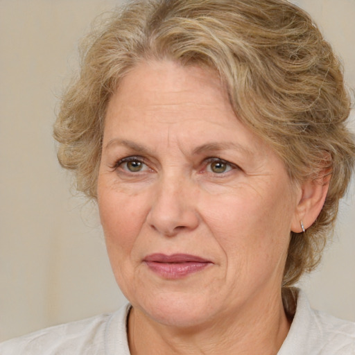 Joyful white middle-aged female with medium  brown hair and brown eyes