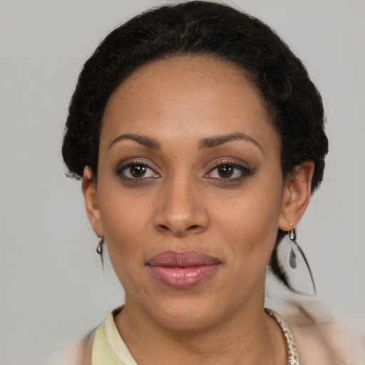 Joyful latino adult female with short  brown hair and brown eyes