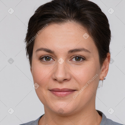 Joyful white adult female with short  brown hair and brown eyes