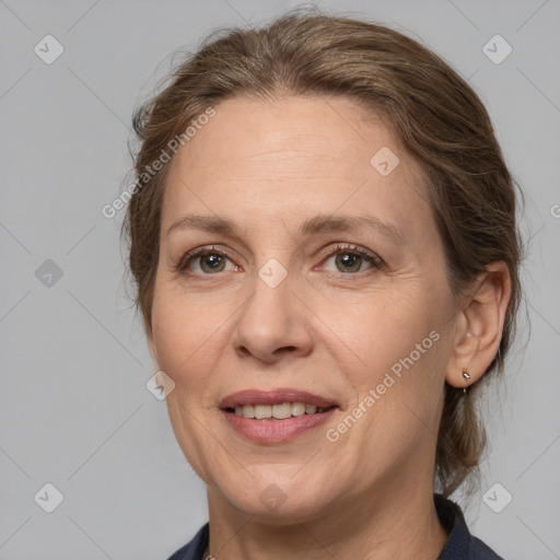 Joyful white adult female with medium  brown hair and brown eyes