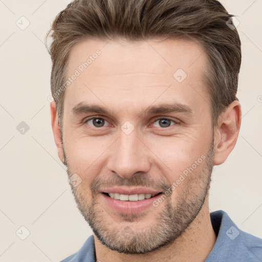 Joyful white adult male with short  brown hair and brown eyes