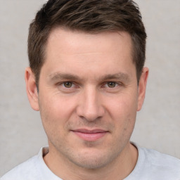 Joyful white adult male with short  brown hair and brown eyes