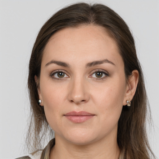 Joyful white young-adult female with long  brown hair and grey eyes