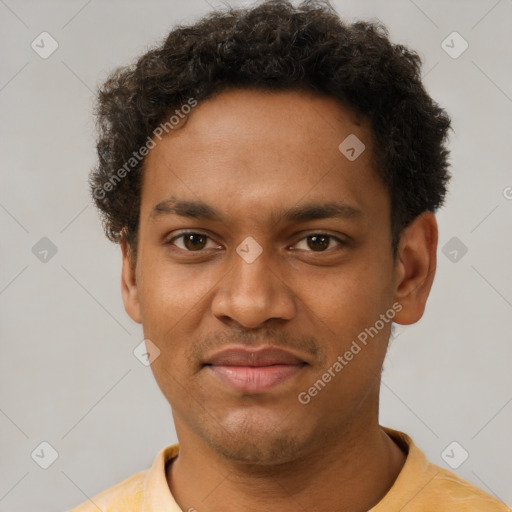 Joyful black young-adult male with short  brown hair and brown eyes
