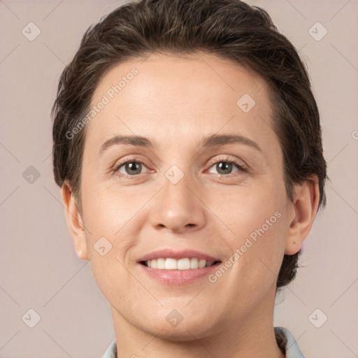 Joyful white young-adult female with short  brown hair and grey eyes