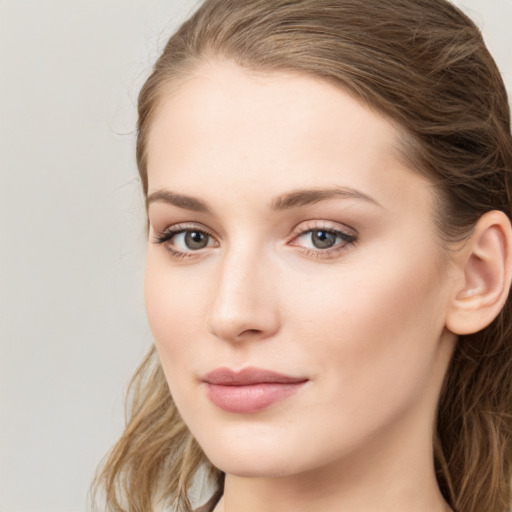 Joyful white young-adult female with long  brown hair and green eyes