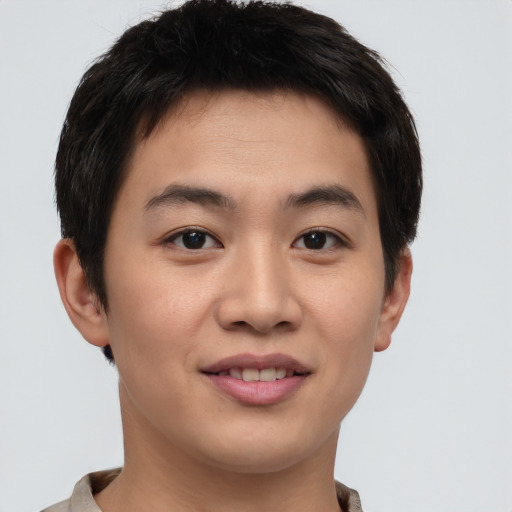 Joyful asian young-adult male with short  brown hair and brown eyes
