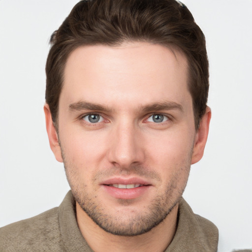 Joyful white young-adult male with short  brown hair and grey eyes