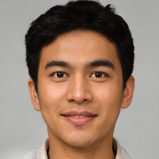 Joyful asian young-adult male with short  black hair and brown eyes