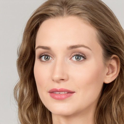 Joyful white young-adult female with long  brown hair and blue eyes