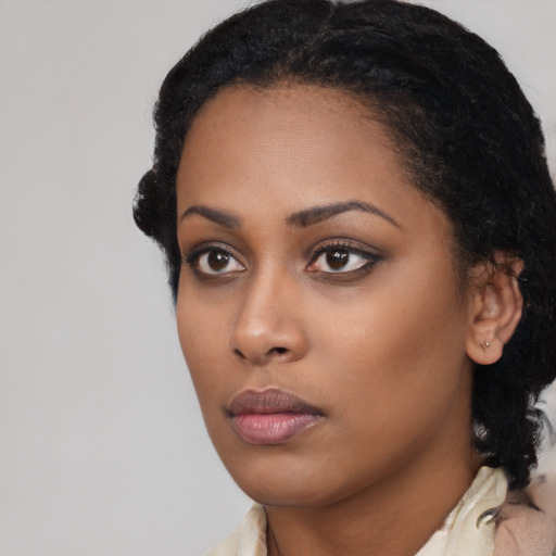 Neutral black young-adult female with medium  black hair and brown eyes