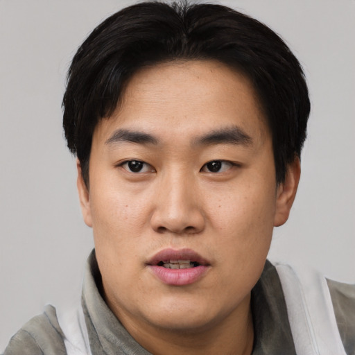 Neutral asian young-adult male with short  black hair and brown eyes