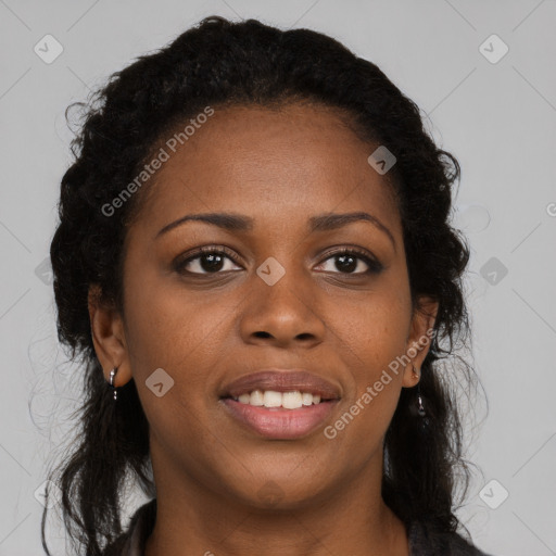 Joyful black young-adult female with long  brown hair and brown eyes