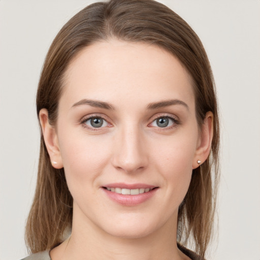 Joyful white young-adult female with long  brown hair and grey eyes