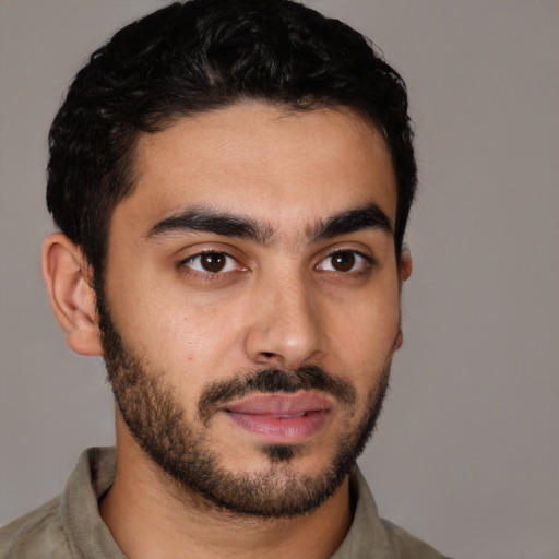 Joyful latino young-adult male with short  brown hair and brown eyes