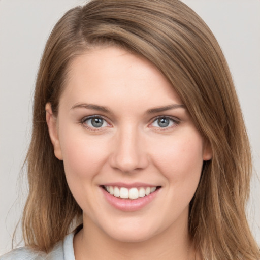 Joyful white young-adult female with long  brown hair and grey eyes