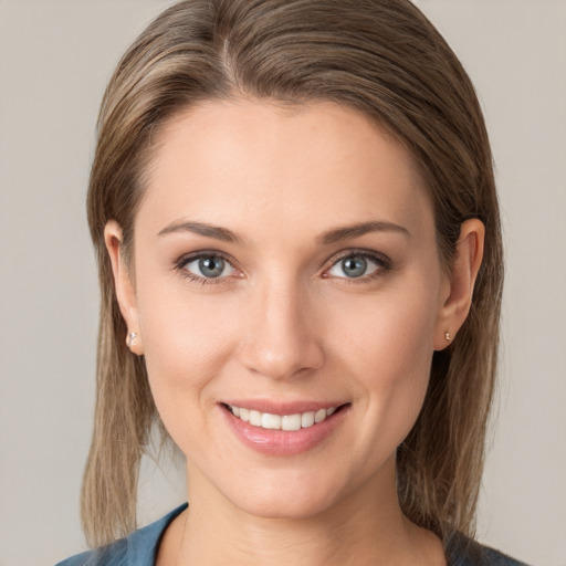 Joyful white young-adult female with medium  brown hair and grey eyes