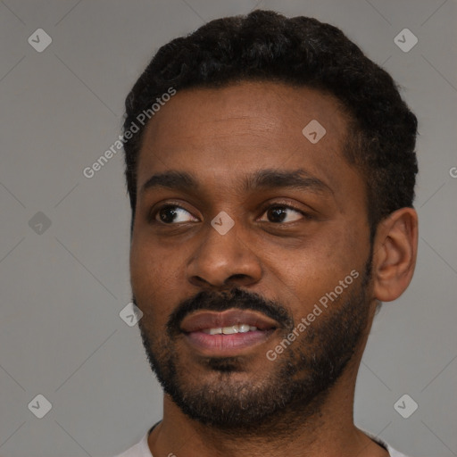 Joyful black young-adult male with short  black hair and brown eyes