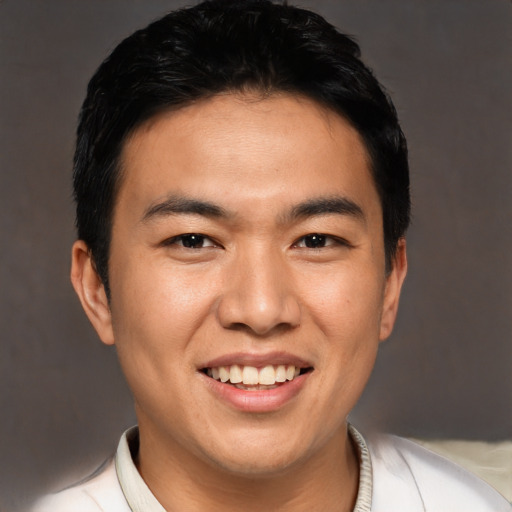 Joyful asian young-adult male with short  black hair and brown eyes