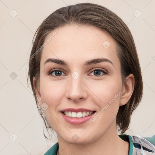 Joyful white young-adult female with medium  brown hair and grey eyes