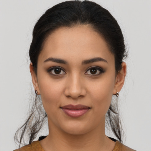 Joyful latino young-adult female with medium  brown hair and brown eyes