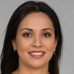 Joyful white young-adult female with long  brown hair and brown eyes