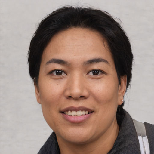 Joyful asian young-adult female with medium  black hair and brown eyes