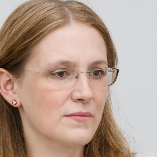 Joyful white young-adult female with long  brown hair and blue eyes