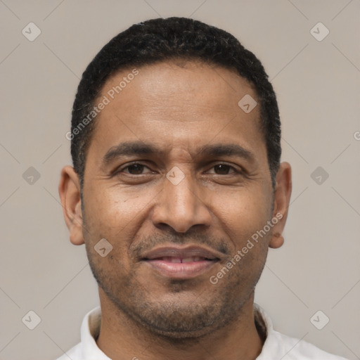 Joyful latino adult male with short  black hair and brown eyes