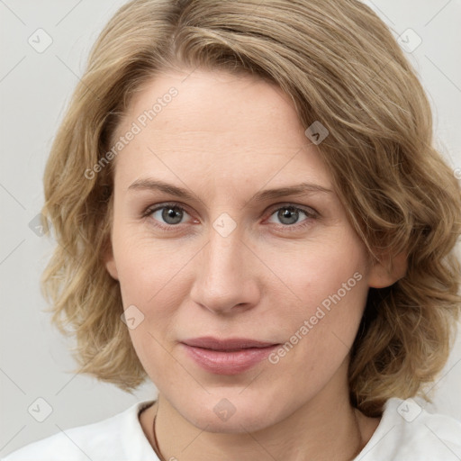 Joyful white young-adult female with medium  brown hair and blue eyes